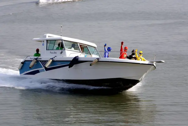 Stock image Well known characters from Disneys Cartoon channel ; the Power Rangers arrive via Speed boat for a press event at the Gateway of India Bombay Mumbai ; Maharashtra ; India 