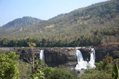 Picnic spot ; landscape Athirappilly waterfall gushing water spray ; District Thrissur ; Kerala ; India clipart