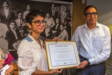 Kiran Rao presenting award to Jagdish Agarwal, Founder of Dinodia Photo Library, Jehangir Art Gallery, Mumbai, India  clipart