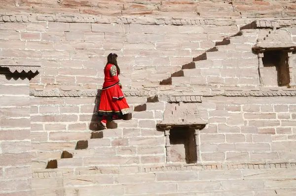 stock image young girl climbing staircase Toorji Ka Jhalara, jodhpur, rajasthan, India, Asia 