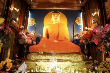huge gilded buddha his hands touched the earth , mahabodhi temple , bihar , india clipart
