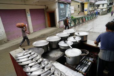 Steel utensils of dhaba roadside restaurant in narrow street, Banjar town, Tirthan Valley, Kullu, Himachal Pradesh, India, Asia  clipart