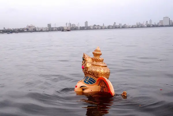 stock image A huge Ganesh idol (elephant headed god) is immersed in to the sea at Girgaum Chowpatty, Bombay now Mumbai, Maharashtra, India 