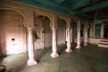 Wooden and pink pillars in temple at Shivneri fort, Taluka Junnar, district Pune, Maharashtra, India. clipart