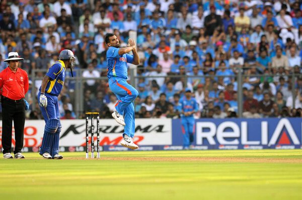 Indian bowler Zaheer Khan bowls while L umpire Aleem Dar C Sri Lankan batsman Thilan Samaraweera looks on during ICC Cricket World Cup finals against Sri Lanka being played at the Wankhede stadium in Mumbai on April 02 2011