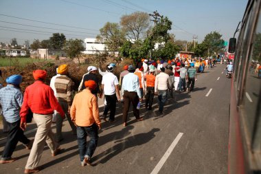 Sikhs devotees marching during Hola Mohalla festival towards Anandpur Sahib in Rupnagar district, Punjab, India  clipart