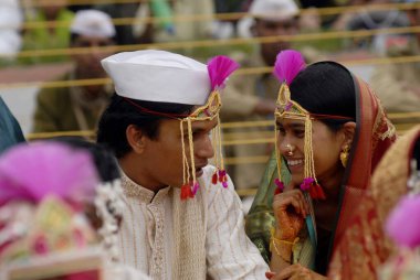 Couples getting married at mass marriage function organized by Sant Nirankari Mission at Airoli, New Bombay now Navi Mumbai, Maharashtra, India    clipart