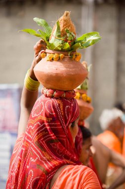 Woman holding ritual pot, kumbh mela, ujjain, madhya pradesh, india, asia  clipart