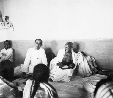 Brijkishna Chandiwalla, Pyarelal Nayar and Mahatma Gandhi laughing with other people during his visit to the North West Frontier Provinces to Afghanistan, October 1938    clipart