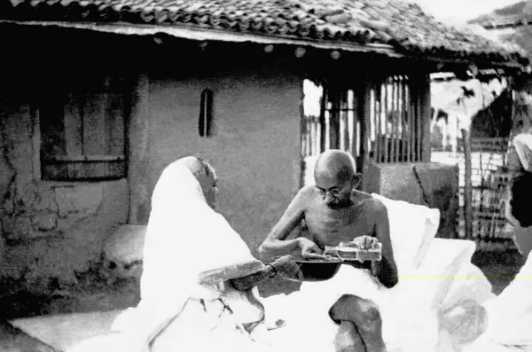 stock image Kasturba Gandhi and Mahatma Gandhi washing his hands and mouth after breakfast talking to US journalist Louis Fischer at Sevagram Ashram, June 1942   