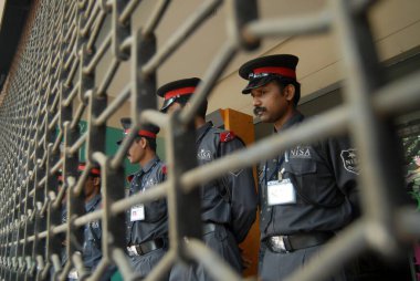 Private security guards near the closed shutter of Big Bazaar department stores in Bombay now Mumbai ; Maharashtra ; India clipart