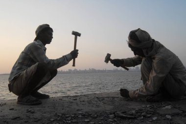 Construction labourers work during sunset at Marine Drive ; Bombay now Mumbai ; Maharashtra ; India clipart