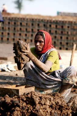 A woman brick maker at the brick factory in a village of Sangli ; Maharashtra ; India clipart