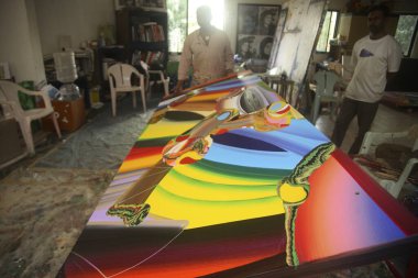 Indian contemporary artist Bose Krishnamachari in his studio working on canvas, Bombay Mumbai, Maharashtra, India  clipart