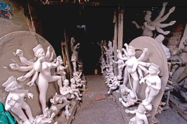 Clay model of goddess Durga with her consorts in process of complete ; Calcutta ; West Bengal ; India clipart