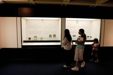 Hong Kong Sanat Müzesi 'ndeki modern Çin sanat sergisinde yürüyen anne ve kızları; Kowloon; Hong Kong 