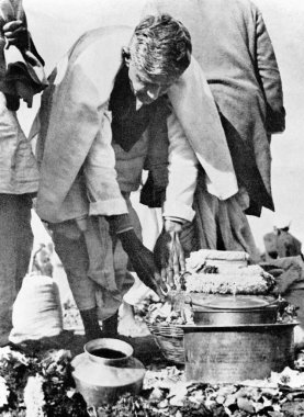 Ramdas Gandhi handling the urn carrying his fathers ashes at Allahabad, Uttar Pradesh, India, February 12, 1948    clipart