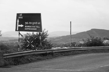 Sign Board Urse or Mumbai via Toll Expressway Talegaon Maharashtra India Asia Sept 2011 clipart