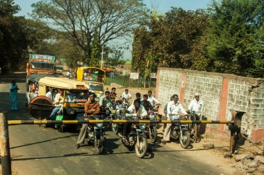 Bikes and cars waiting, Railway level crossing, Ratnagiri, Konkan, Maharashtra, India, Asia  clipart