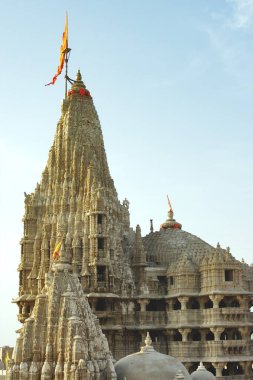 Dome with orange flag of dwarkadeesh at dwarka district, Jamnagar, Gujarat, India  clipart