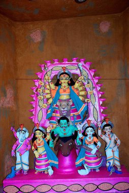 Durga clay model killing demon mahishasura with statues of kartikeya ganesha and lakshmi saraswati on Durga puja clipart