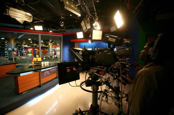 Cameraman shooting anchor with news in newsroom of cnbc channel , Bombay Mumbai , Maharashtra , India