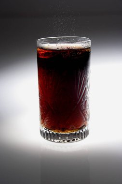 carbonated drink in transparent glass with ice cubes clipart