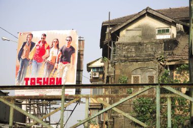 Old building and Bollywood hindi movie poster Tashan at Grant road, Bombay now Mumbai, Maharashtra, India    clipart