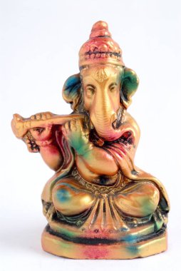 Colourful statue of lord Ganesha elephant headed god playing shehnai flute , India clipart