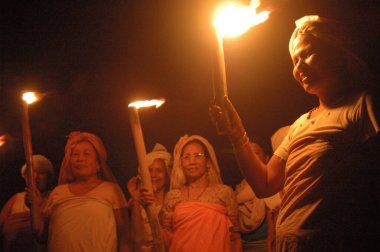 Meira paibis (torch bearers) present themselves with burning torches to spread light on their affected rights as women and mothers, Imphal, Manipur, India  clipart