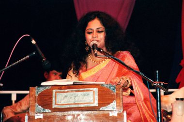 Ghazal singer on harmonium   clipart