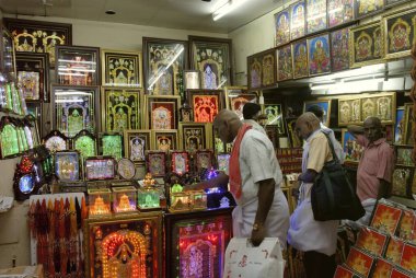 Devotees purchasing pictures at Tirumalai Tirupathi, Andhra Pradesh, India  clipart