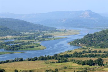 meandering water Vashishti River mountain ranges Sahyadri Mangalore tiled roof houses greenery Parshuram Ghat Chiplun Ratnagiri clipart