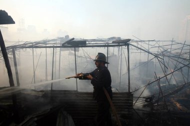 Versova 'daki Mhada kolonisinde patlak veren yangını söndürmeye çalışan itfaiyeci; Andheri; Bombay şimdi Mumbai; Maharashtra; Hindistan