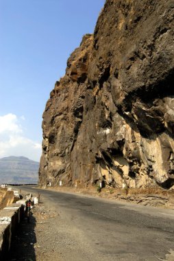 Zigzag Ghat road constructed by cutting very hard black rock of Sahyadri mountain at Malshej Ghat ; District Thane ; Maharashtra ; India clipart