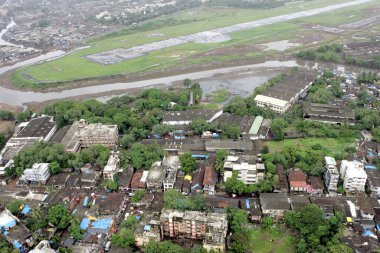 An aerial view of area surroundings runways also Mithi river flowing through airport area at Mumbais Chhatrapati Shivaji Maharaj International airport at Sahar ; Bombay Mumbai ; Maharashtra ; India  clipart