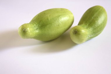 Green vegetable , kakri cucumbers cucumis utilissimus on white background clipart