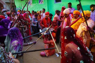 Kadınlar erkekleri sopayla dövüyor, Lathmar Holi festivali, Mathura, Uttar Pradesh, Hindistan, Asya 