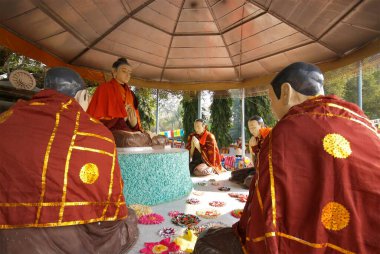 Statues of lord Buddha and his disciples at Dhamma chakka pavattana sutta wheel of law at Sarnath, Varanasi, Uttar Pradesh, India  clipart