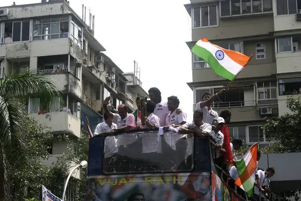 stock image Twenty 20 team players wave tri color Indian flags during victory procession, Bombay Mumbai, Maharashtra, India; India   