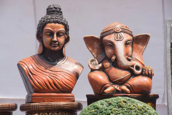 stock image idols of Lord Ganesha and Buddha, kept for sell, Thane, Maharashtra, India, Asia