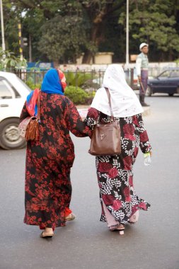 Yüzü sokakta yürüyen iki orta yaşlı Müslüman kadın; Dhaka; Bangladeş