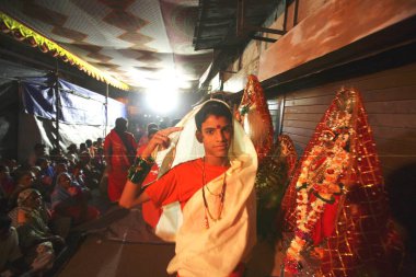 Eunuch dressed in traditional white sari with green bangles and big red bindi on his forehead during wedding of eunuchs on occasion of Bewa Purnima at Ghatkopar ; Bombay now Mumbai ; Maharashtra ; India clipart