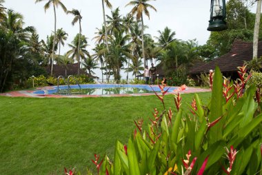 Couple at swimming pool in heritage lake resort ; Kuttanad ; Alleppey Alappuzha ; Kerala ; India  clipart