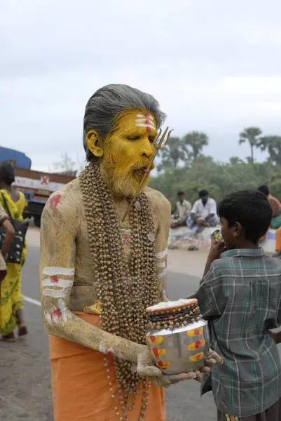 stock image Pilgrim decorated with sacred ash and trance trident-like spears pierced through cheeks; Visakam festival ; Tiruchendur ; Tamil Nadu ; India