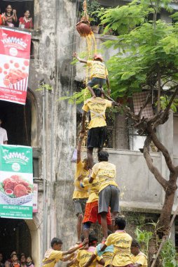 Janmashtami festivali, Mumbai, Maharashtra, Hindistan ve Asya 'da Dahi Handi' yi yıkmak için insan piramidi yapan adamlar.