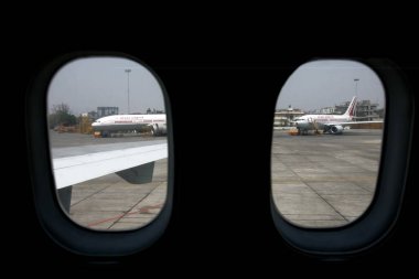 Two Air India flights can be seen from the windows of the airplane parked at the Chhatrapati Shivaji International Airport formerly called as Sahar International airport, Bombay Mumbai, Maharashtra, India  clipart