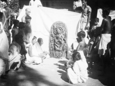 1946 'da Noakhali Doğu Bengal' de insanların baktığı bir ilah taşı.   