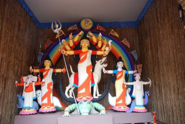 Durga clay model with statues of kartikeya ganesha and lakshmi saraswati on Durga puja  clipart