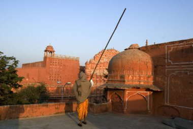 Rajasthani man looking at Hawa Mahal ; Jaipur; Rajasthan ; India clipart